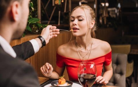 Date night man feeding woman dessert