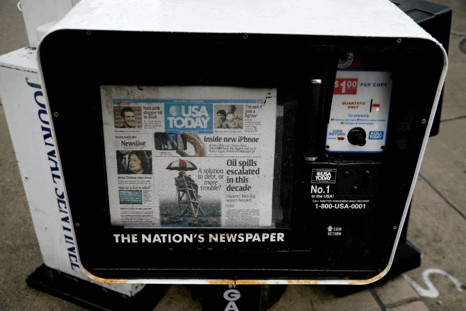 Newspaper dispenser with a copy of USA Today